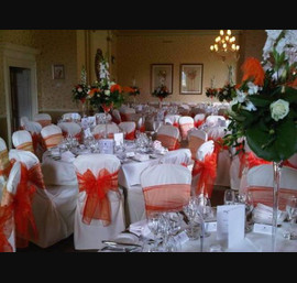 Burnt Orange bows on Butter Chair Covers at Close House Hotel