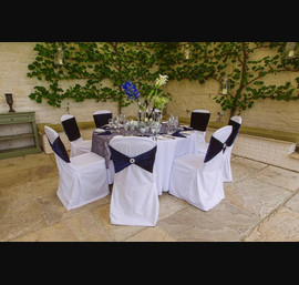 The Orangery - Set for Private Dining. Midnight Velvet Chair Bands accessorised with a diamante brooch