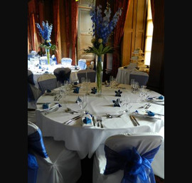 Navy blue sashes on white linen at Crathorne Hall