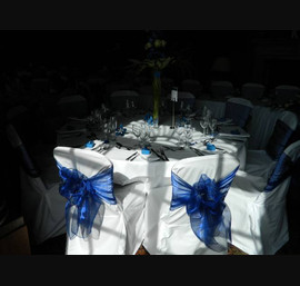 Blue sashes on white linen at Crathorne Hall