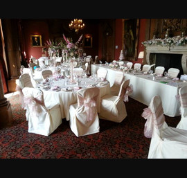 Dusky pink and champagne double bows on butter linen at Crathorne Hall