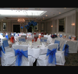 Royal Blue and Orange Bows and White Chair Covers - Reception in Rockliffe Suite