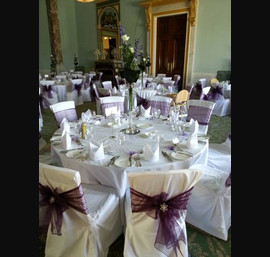 Aubergine organza sashes on white linen at Wynyard Hall