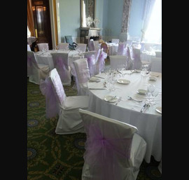 Lilac sashes on white linen at Wynyard Hall