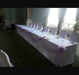 Lilac sashes on white linen at Wynyard Hall