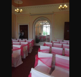 White Chair Covers with Fuschia Organza Sashes at Alston Hall, Longridge