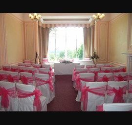 White Chair Covers with Fuschia Organza Sashes at Alston Hall, Longridge