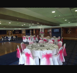 Fuschia Pink Organza Sashes on White Chair covers at Ewood Park, Blackburn