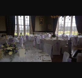 White chair covers with lilac organza sash at Swinton park