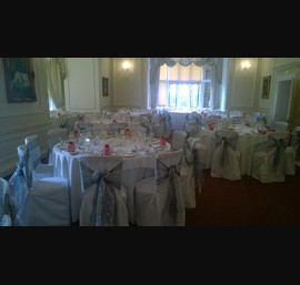 White chair covers with silver organza sashes with lace inserts at Goldsborough Hall