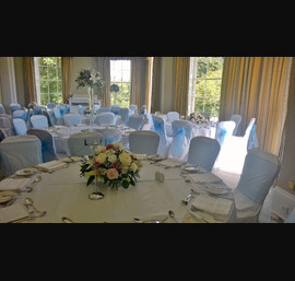 White chair covers with cornflower organza sashes at Rudding Park