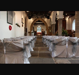 Silver organza sashes on white chair covers, All Saints Church, Kirkby Overblow