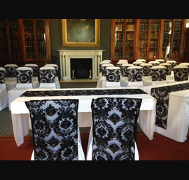 Black Flocked organza sash and chair veil on white chair covers. The Library Rudding Park