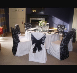 Black Flocked organza sash and chair veil on white chair covers. Rudding Park