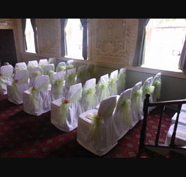 Apple Organza sashes on white chair covers. The Bridge Hotel, Walshford