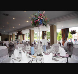 Pink and silver organza sashes. Silver pintuck table runner with pink lace overlay on white table runners at The Bridge Hotel