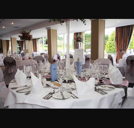 Pink and silver organza sashes. Silver pintuck table runner with pink lace overlay on white table runners at The Bridge Hotel