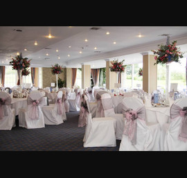 Pink and silver organza sashes. Silver pintuck table runner with pink lace overlay on white table runners at The Bridge Hotel