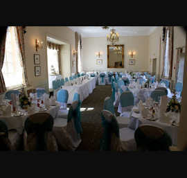 Teal Organza sashes on white chair covers. The Bridge Hotel, Walshford