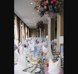 Pink and silver organza sashes. Silver pintuck table runner with pink lace overlay on white table runners at The Bridge Hotel