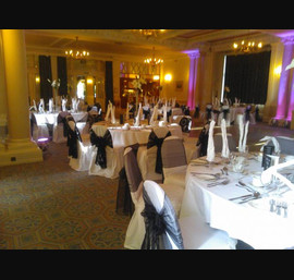 Black organza and flocked sashes on white chair covers at The Cairn Hotel, Harrogate