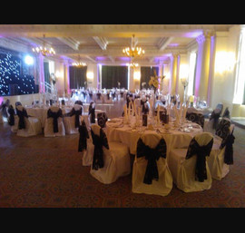 Black organza and flocked sashes on white chair covers at The Cairn Hotel, Harrogate