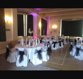 Black organza and flocked sashes on white chair covers at The Cairn Hotel, Harrogate