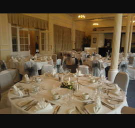 Silver organza sashes on white chair covers at The Cairn Hotel, Harrogate