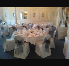 Silver organza sashes on white chair covers at The Cairn Hotel, Harrogate