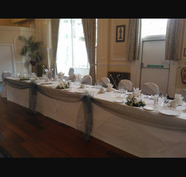 Silver organza sashes on white chair covers at The Cairn Hotel, Harrogate