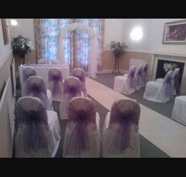 Purple organza sashes on white chair covers at The Cairn Hotel, Harrogate