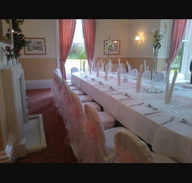 Pink organza sashes on white chair covers at The Cairn Hotel, Harrogate