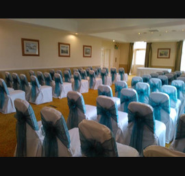 Teal Organza sashes on white chair covers at Hollins Hall, Bradford