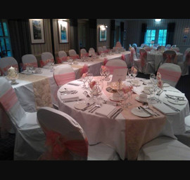 Peach and Champagne organza sashes on white chair covers, Peach organza and Champage flocked organza table runners at the Chevin Lodge