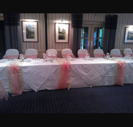 Peach and Champagne organza sashes on white chair covers, Peach organza and Champage flocked organza table runners at The Chevin Lodge