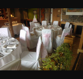 Baby Pink organza sashes on white chair covers at Coniston Hall