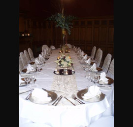 Gold embroidered organza sashes on white chair covers at The Crown Hotel, Harrogate