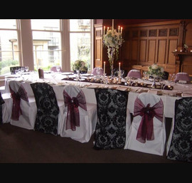 The Crown Hotel, Black flocked organza chair veil and wine organza bows