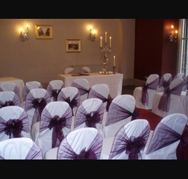 Aubergine organza sashes on white chair covers at The Crown Hotel, Harrogate