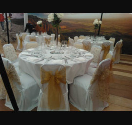 Gold embroidered organza and gold sashes on white chair covers. The Welcome to Yorkshire VIP marquee at the Great Yorkshire Show