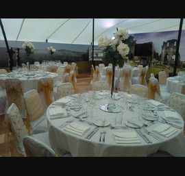Gold embroidered organza and gold sashes on white chair covers. The Welcome to Yorkshire VIP marquee at the Great Yorkshire Show