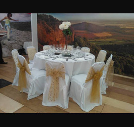 Gold embroidered organza and gold sashes on white chair covers. The Welcome to Yorkshire VIP marquee at the Great Yorkshire Show
