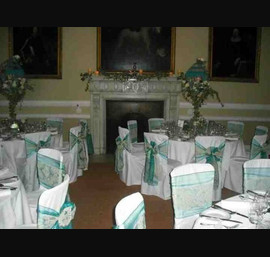 Teal organza and Champagne flocked double sash on white chair covers at Ripley Castle