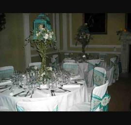 Teal organza and Champagne flocked double sash on white chair covers at Ripley Castle