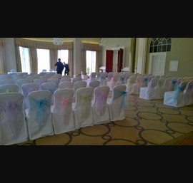 Various Pastal Organza sashes on White Chair Covers at Rudding Park, Harrogate