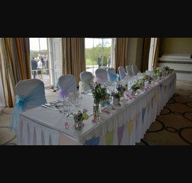 Various Pastal Organza sashes on White Chair Covers at Rudding Park, Harrogate