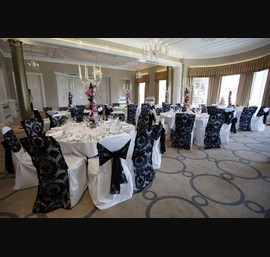 Black Flocked organza sash and chair veil on white chair covers at Rudding Park photograph by baughanphotography.co.uk