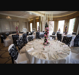 Black Flocked organza sash and chair veil on white chair covers at Rudding Park photograph by baughanphotography.co.uk
