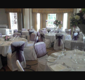 Aubergine Organza sashes on white chair covers, at Rudding Park