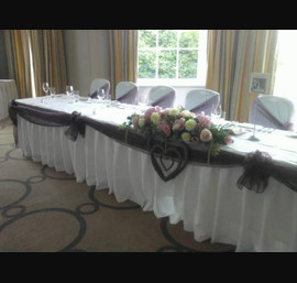 Aubergine Satin Swags, Aubergine Organza sashes on white chair covers, top table at Rudding Park